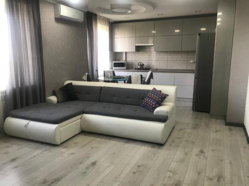 a living room with a couch and a kitchen at Квартира город Умань in Umanʼ