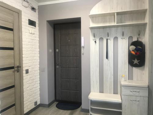 a room with a wooden door and a room with a closet at Квартира город Умань in Uman