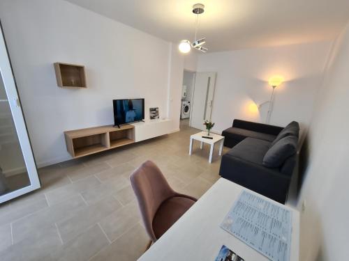 a living room with a couch and a tv at Mia Apartament in Tulcea