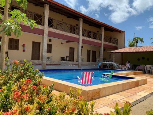 a swimming pool with two lawn chairs in a house at Dáriu's Pousada in Prea