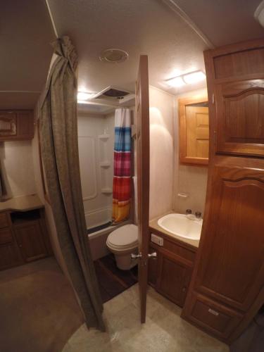 a small bathroom with a toilet and a sink at Tulum Nueve in Tulum