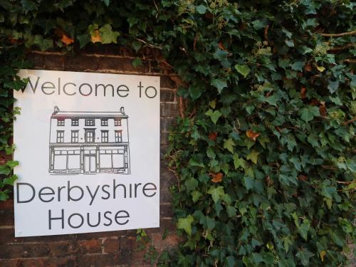 a sign for a house on a wall at Beresford Dale in Ashbourne