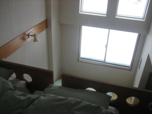 Ένα ή περισσότερα κρεβάτια σε δωμάτιο στο Lodge Nakajima