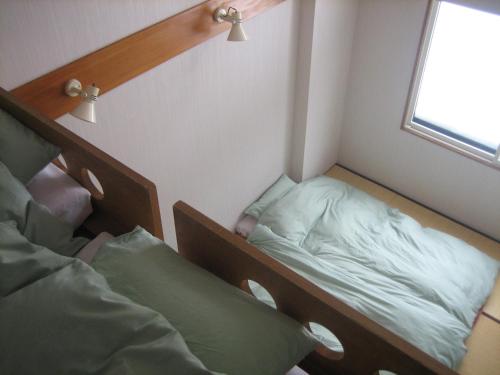 Ένα ή περισσότερα κρεβάτια σε δωμάτιο στο Lodge Nakajima