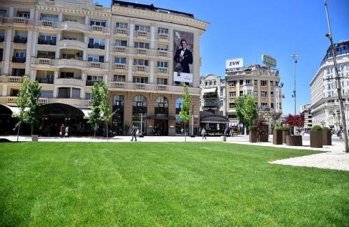 a park in front of a large building at Skopje City Square View in Skopje