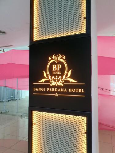 a sign for a hotel in front of a building at Bangi Perdana Hotel in Bangi