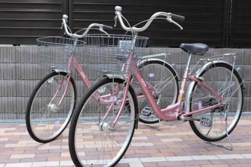 two bikes parked next to each other on a sidewalk at Hot Spring Osaka Hinode Hotel Nipponbashi in Osaka