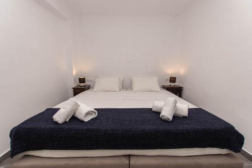a bedroom with a bed with two pillows on it at Peristeronas Village in Klouvas