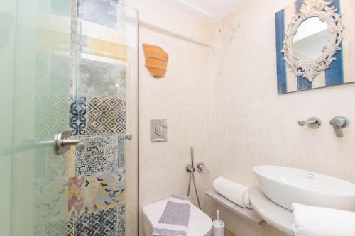 a bathroom with a shower and a toilet and a sink at Peristeronas Village in Klouvas