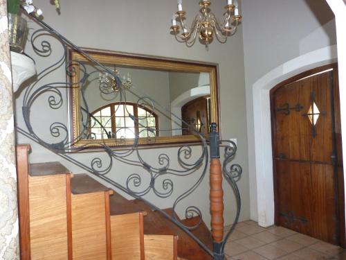 a spiral staircase with a mirror and a chandelier at Royston Hall Historical Guesthouse in Umtentweni