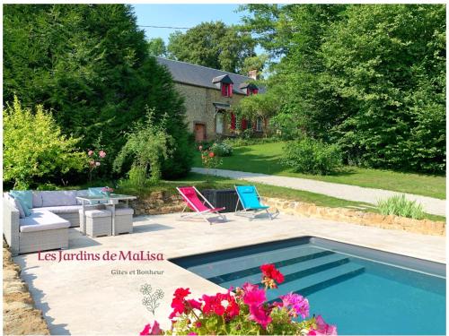 a backyard with a swimming pool and a house at Les Jardins de MaLisa in Ferrières-la-Verrerie