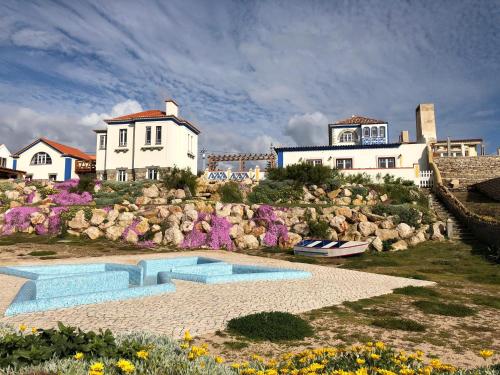 a house on a rocky hill with a swimming pool at Chalet O Amorzinho Sintra Praia in Sintra