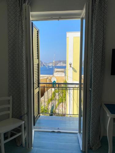 an open door to a balcony with a view of the ocean at Sky Ponza - Immobilevante in Ponza