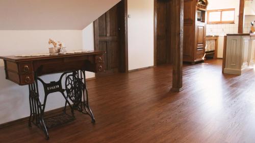 a wooden table in a room with a wooden floor at Doubický Venkov in Doubice