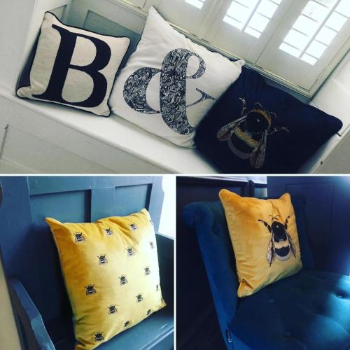 three pictures of pillows with the letter b on a couch at Belle Vue Guest House in Denver