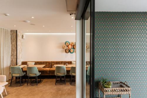 a dining room with a table and chairs at Beach Hotel Helios by CW Hotel Collection in Blankenberge