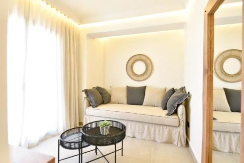 a living room with a couch and a table at Tropicana Hotel , Suites & Villas Mykonos in Paradise Beach