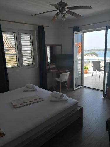 a bedroom with a bed and a view of the ocean at Apartments Kresic in Hvar