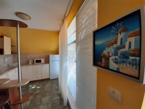 a kitchen with a large television on a wall at Guest House Diel in Veliko Tŭrnovo