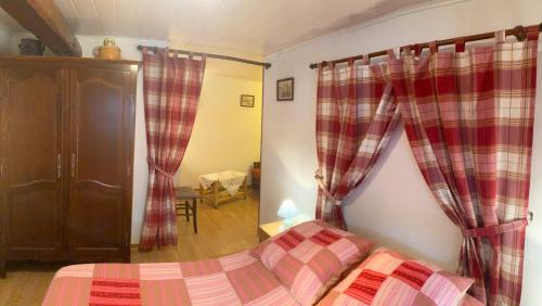 a bedroom with a bed and curtains in a room at Gite Lammer in Artolsheim