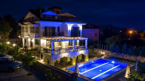 a house with a swimming pool at night at Villa TN - Fethiye in Fethiye