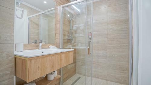 a bathroom with a sink and a shower at Monarch House in Braşov