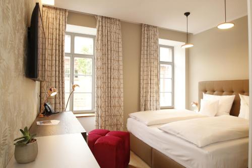 a small bedroom with a bed and a window at Amelie No 1 Hotel & Appartements in Landau in der Pfalz