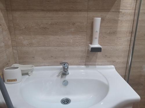 a bathroom with a white sink and a toilet at Sandanski Apartments Top Center in Sandanski