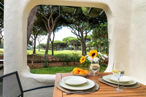 a table with a bowl of oranges and glasses of wine at Charming Villa Golf & Beach in Cascais