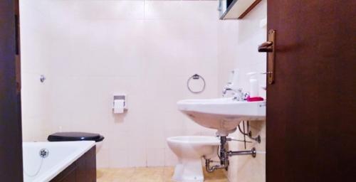 a white bathroom with a sink and a toilet at La Veranda sul Matese - Appartamento a Campitello Matese in San Massimo