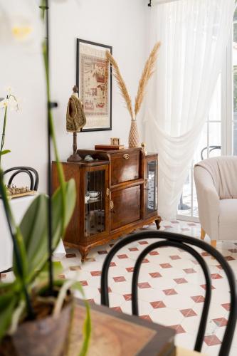 a living room with a wooden cabinet and a table at KIANA KALEİÇİ in Antalya
