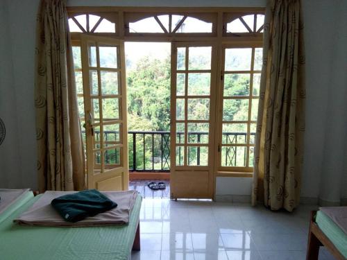 a room with a large window and a room with a door at Green View Ella in Ella