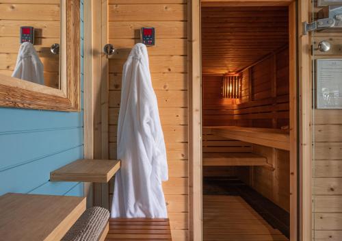 a sauna with a towel hanging in a cabin at La Marine de Loire Hôtel & Spa in Montsoreau