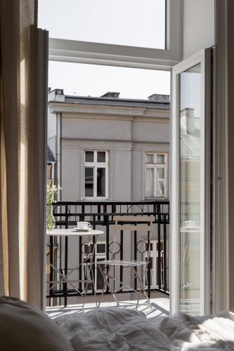 a room with a balcony with a table and a view at Lwowska Studios - STAYINWARSAW in Warsaw