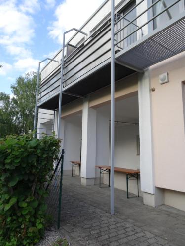 a patio with a picnic table underneath a building at Airport Park Hotel MUC in Hallbergmoos
