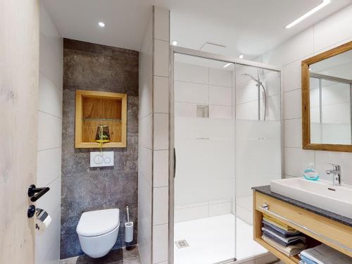 a bathroom with a shower and a toilet and a sink at Erbhof Hinterrain in Leogang