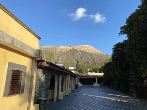 an empty street with a mountain in the background at Hotel Al Togo Fitness & Relax in Vulcano