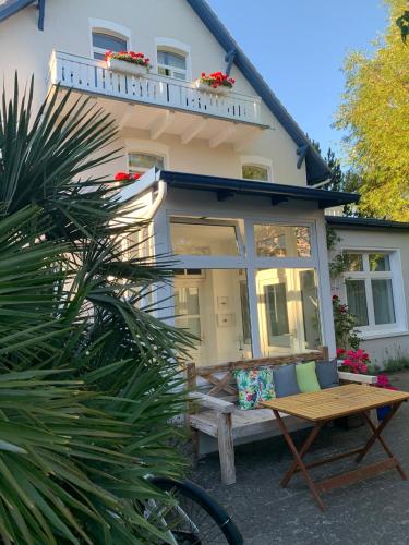 a house with a bench in front of it at Strandhaus WOTAN in Kühlungsborn
