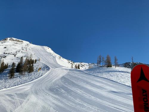 a snow covered mountain with a road in the snow at Ausseerhaus im Grünen in Äussere Kainisch