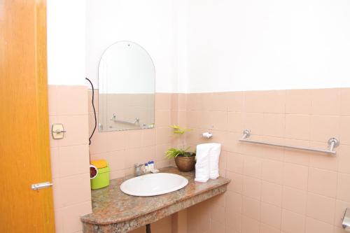 a bathroom with a sink and a mirror at Hotel Nathaliya in Seeduwa