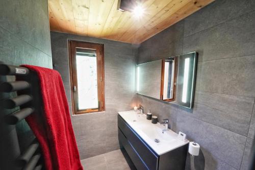 a bathroom with a sink and a mirror at La Ménandière in Megève
