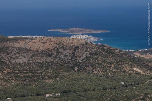 an aerial view of a mountain with islands in the ocean at Traditional Windmill-Milos in Kroústas
