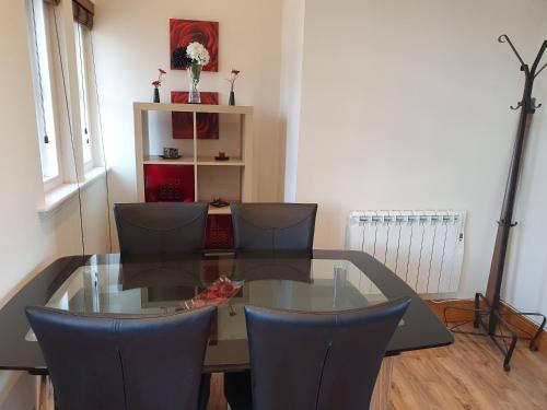 a dining room with a glass table and chairs at Marina Court LA14 2HL in Barrow in Furness