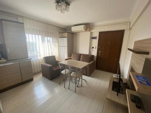 a small living room with a table and chairs at My Rezidans Hotel in Manisa