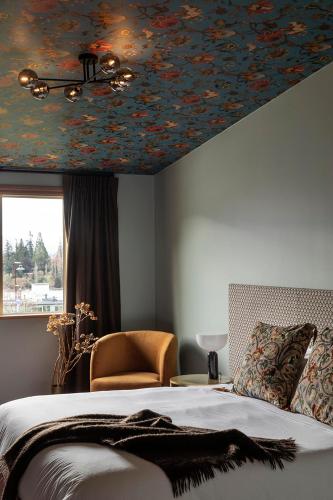 a bedroom with a flower patterned ceiling and a bed at The Dairy Hotel Queenstown, A Naumi Chapter in Queenstown