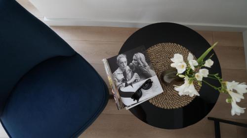 a table with a plate with a picture and flowers at MD Design Hotel - Portal del Real in Valencia