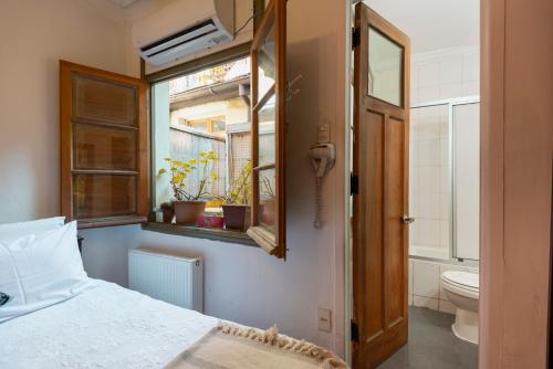 1 dormitorio con cama, ventana y aseo en Providencia Bed & Breakfast en Santiago