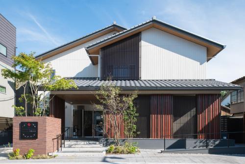 a house with a black and white facade at GRAND BASE Hakata Gofuku in Fukuoka