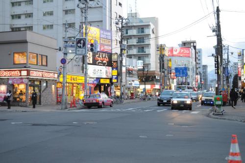 a busy city street with cars driving down the street at Hotel Sapporo Sun Plaza in Sapporo