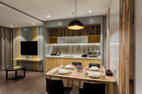 a kitchen and dining room with a table and chairs at The Granite Luxury Hotel Penang in George Town